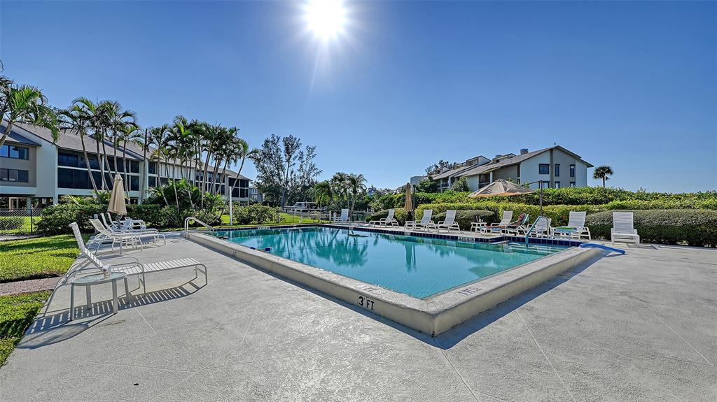 3850 Mariners Walk, Unit 714 Cortez, FL 34215 - Photo 27 of 59 a view of a house with pool and chairs