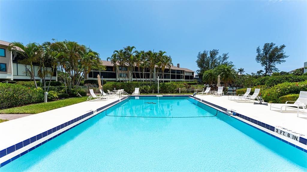 3850 Mariners Walk, Unit 714 Cortez, FL 34215 - Photo 29 of 59 a view of a swimming pool with a patio and a yard