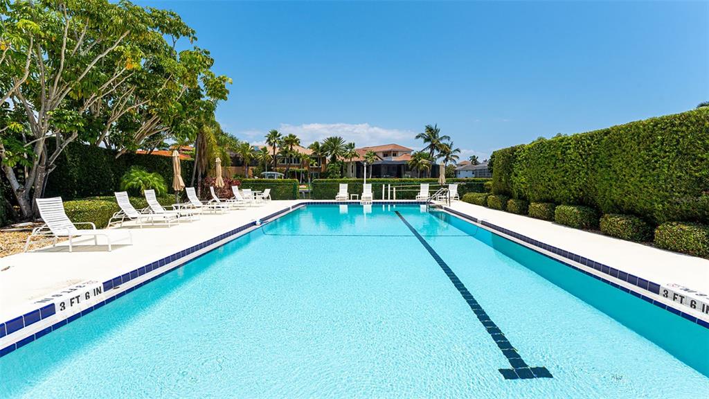 3850 Mariners Walk, Unit 714 Cortez, FL 34215 - Photo 34 of 59 a view of swimming pool with chairs