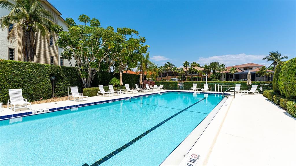 3850 Mariners Walk, Unit 714 Cortez, FL 34215 - Photo 35 of 59 a view of swimming pool with chairs