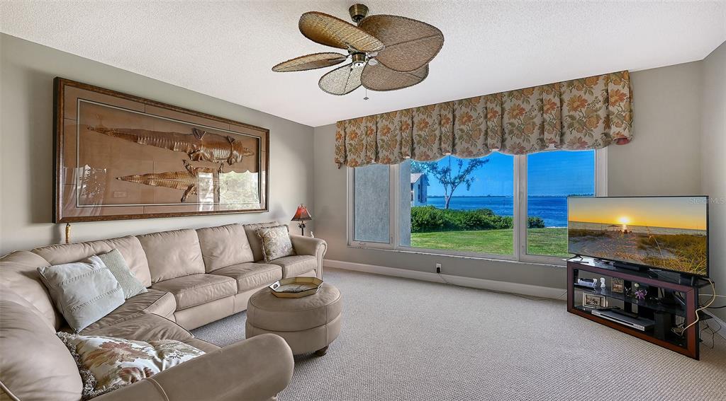 3850 Mariners Walk, Unit 714 Cortez, FL 34215 - Photo 6 of 59 a living room with furniture and a flat screen tv