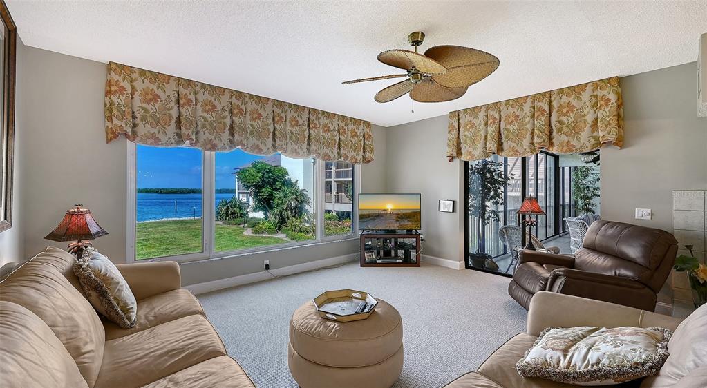 3850 Mariners Walk, Unit 714 Cortez, FL 34215 - Photo 7 of 59 a living room with furniture and a large window