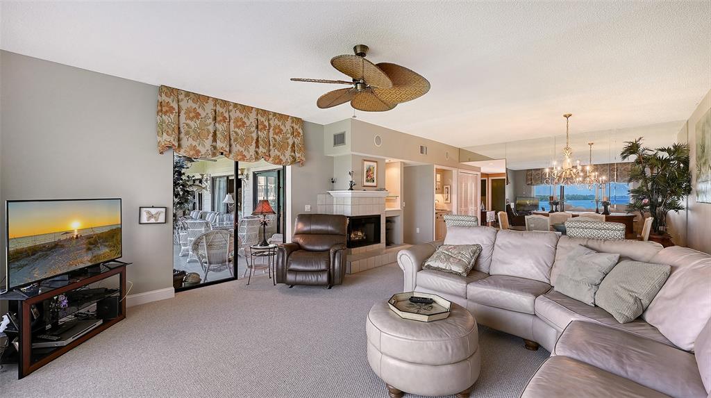 3850 Mariners Walk, Unit 714 Cortez, FL 34215 - Photo 9 of 59 a living room with furniture and a flat screen tv