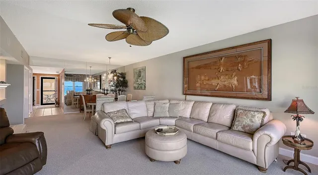 a dining room with furniture a chandelier and window