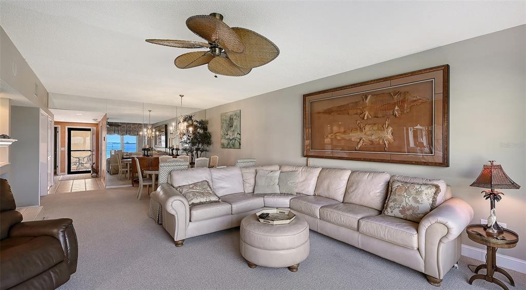 3850 Mariners Walk, Unit 714 Cortez, FL 34215 - Photo 10 of 59 a living room with furniture a ceiling fan and a window