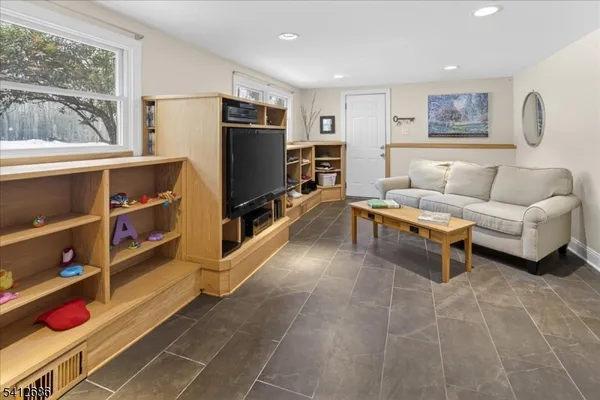 a living room with furniture cabinets and a flat screen tv