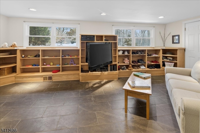 947 Cherry Hill Road Princeton, NJ 08540 - Photo 17 of 45 a living room with furniture a flat screen tv and floor to ceiling window