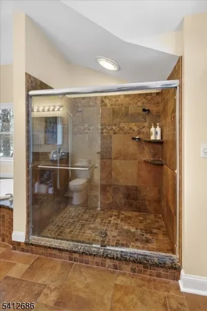 a bathroom with a glass shower door