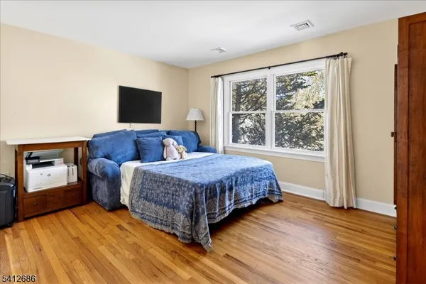 a bedroom with a large bed and a window