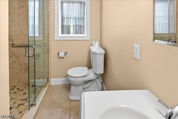 a bathroom with a toilet and a shower