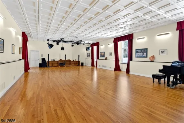 a view of a hall with wooden floor