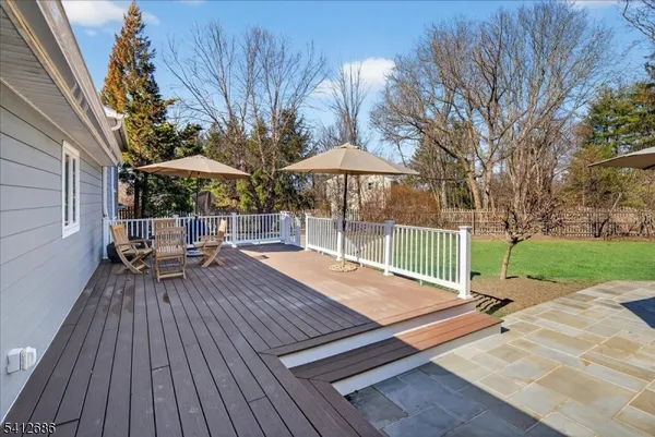 a view of a house with a yard and sitting area