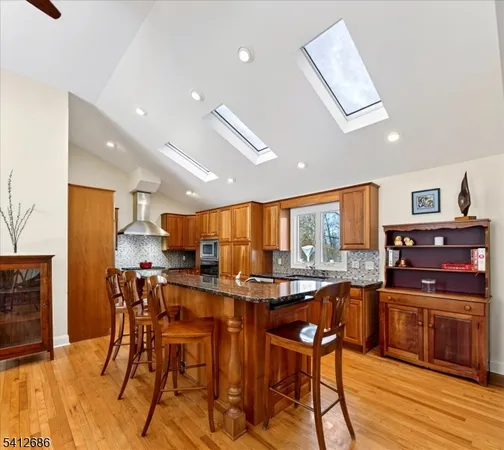 a kitchen with stainless steel appliances kitchen island granite countertop a sink and cabinets