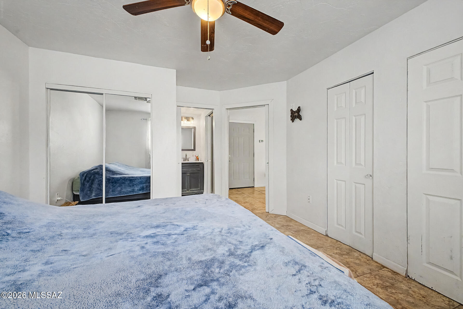 4231 East Pinal Street Tucson, AZ 85739 - Photo 33 of 36 a view of a livingroom with a chandelier fan and wooden floor