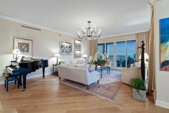 a bedroom with a large bed couch and a large window