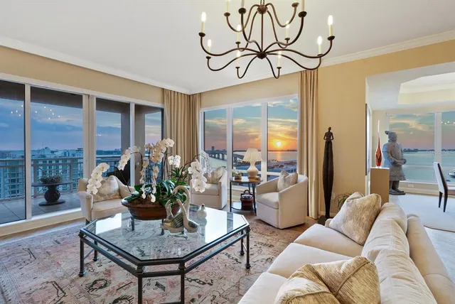 a living room with furniture and large windows