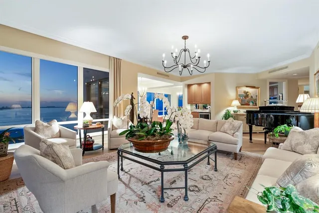 a living room with furniture a rug and a chandelier