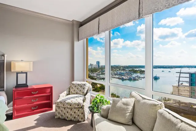 a living room with furniture fireplace and a large window