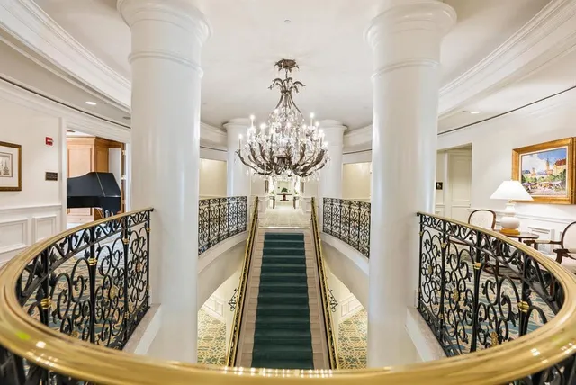 a living room with furniture and a piano