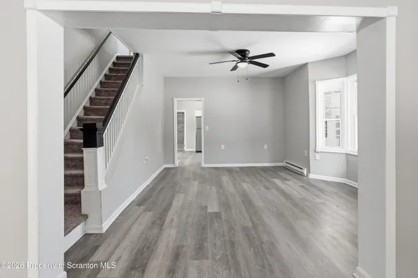 wooden floor in an empty room with a window