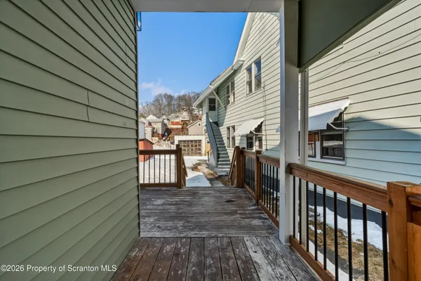 a view of a patio with wooden floor