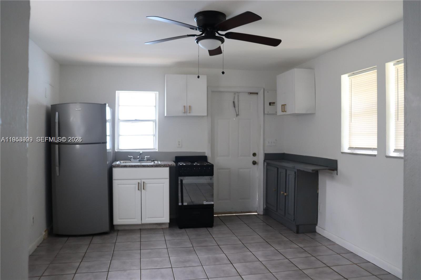 5743 Lincoln Street, Unit 2 Hollywood, FL 33021 - Photo 2 of 5 a kitchen with stainless steel appliances granite countertop a refrigerator and a sink