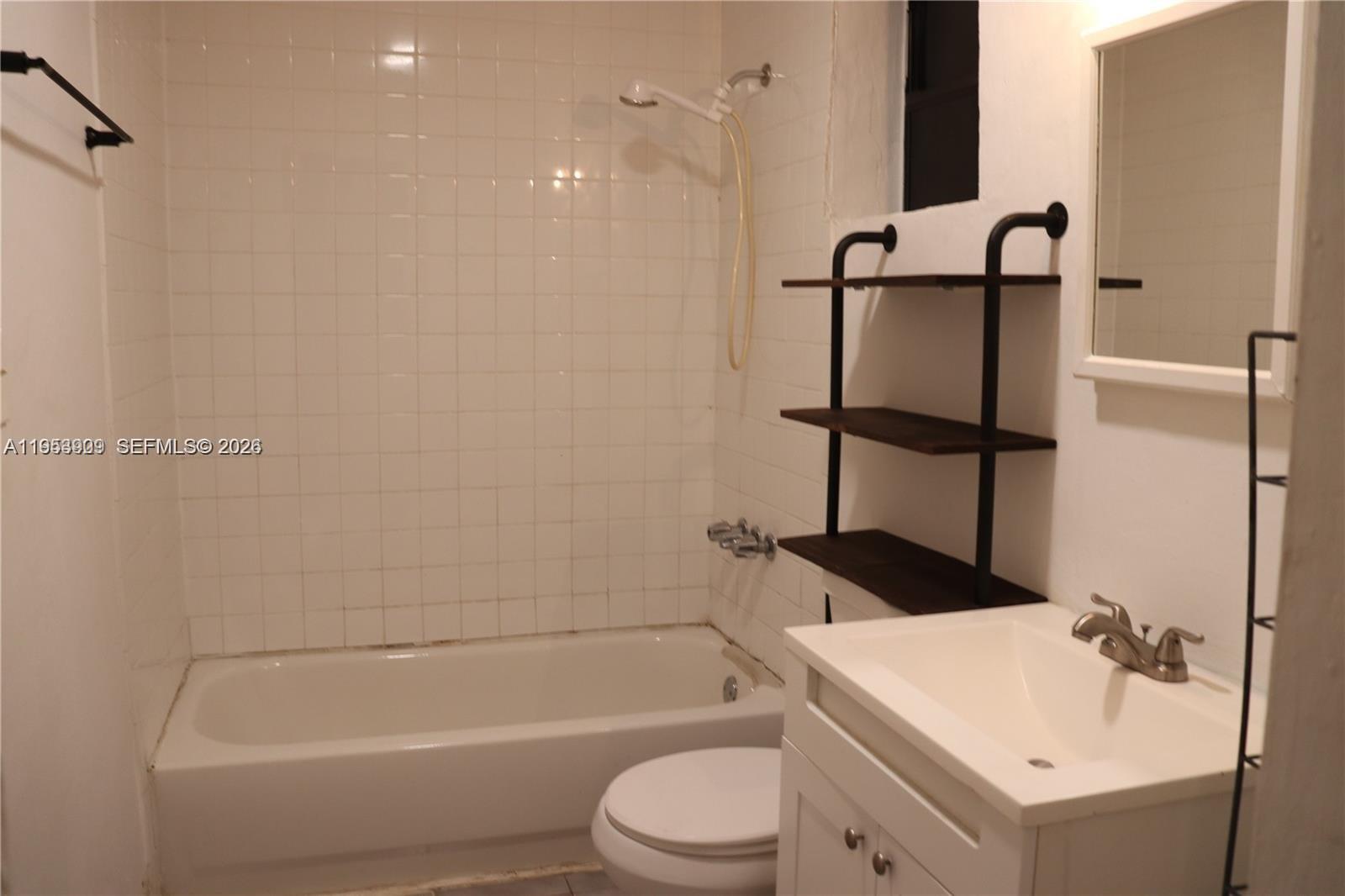 5743 Lincoln Street, Unit 2 Hollywood, FL 33021 - Photo 4 of 5 a bathroom with a sink toilet and shower