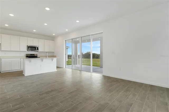 a view of a kitchen with a sink and a refrigerator