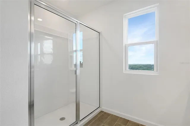 a bathroom with a glass shower door
