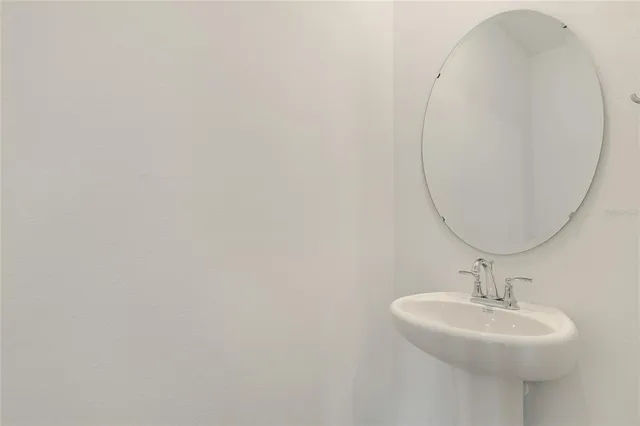 a bathroom with a sink a mirror and a toilet