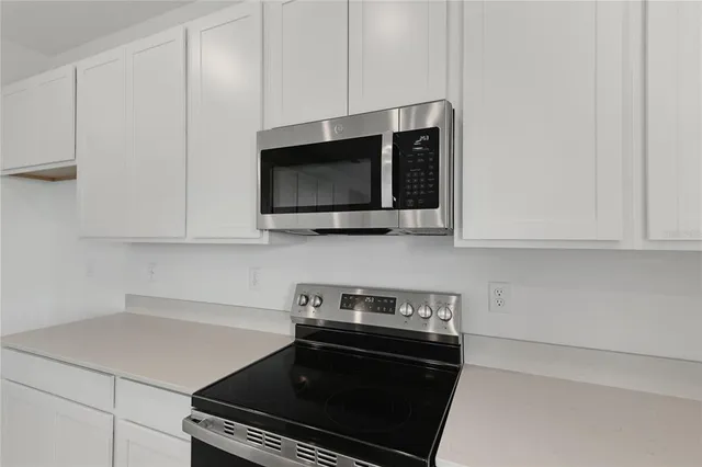 a kitchen with a stove and a microwave