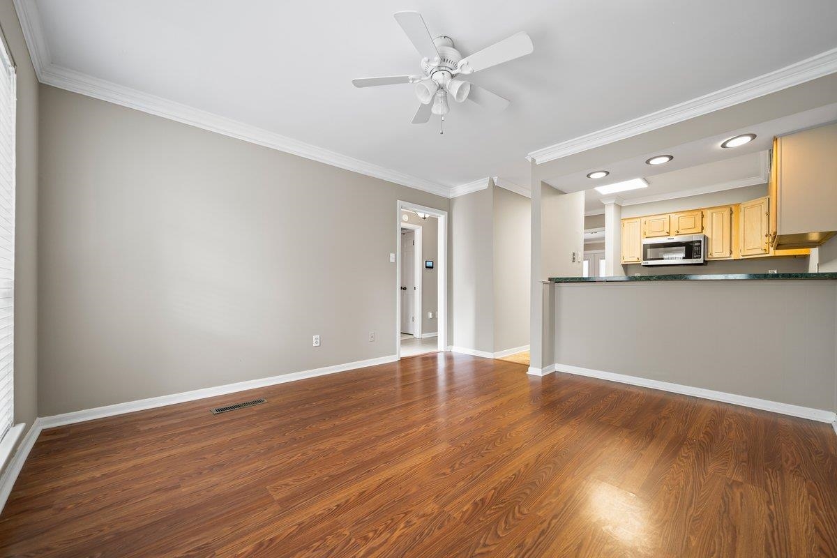 6942 Amberly Road, Unit 6942 Memphis, TN 38119 - Photo 8 of 23 a view of a kitchen with a sink and wooden floor