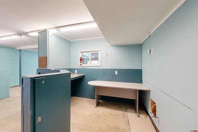 a view of a big room with windows and chandelier