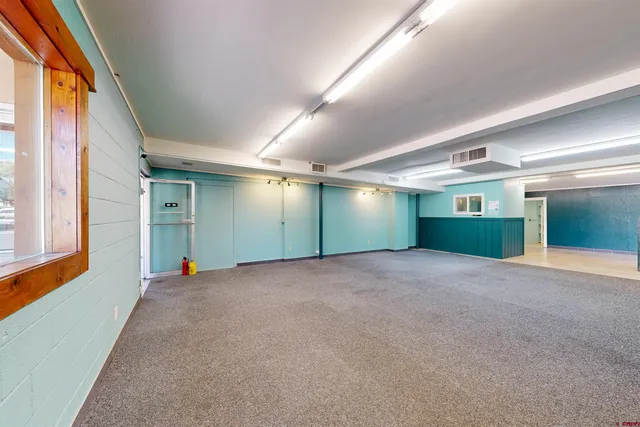 a bathroom with a toilet and a mirror