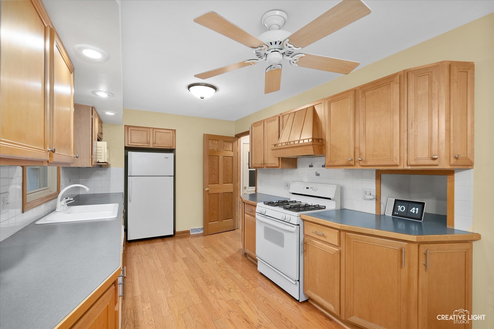 131 Terry Drive Sugar Grove, IL 60554 - Photo 5 of 27 a kitchen with stainless steel appliances granite countertop a sink a stove a refrigerator cabinets and wooden floor