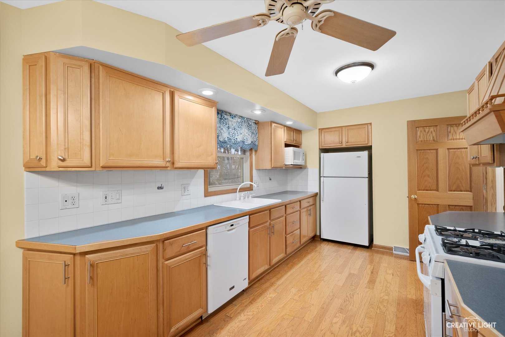 131 Terry Drive Sugar Grove, IL 60554 - Photo 6 of 27 a kitchen with stainless steel appliances granite countertop a refrigerator a sink dishwasher a stove with wooden cabinets and floor