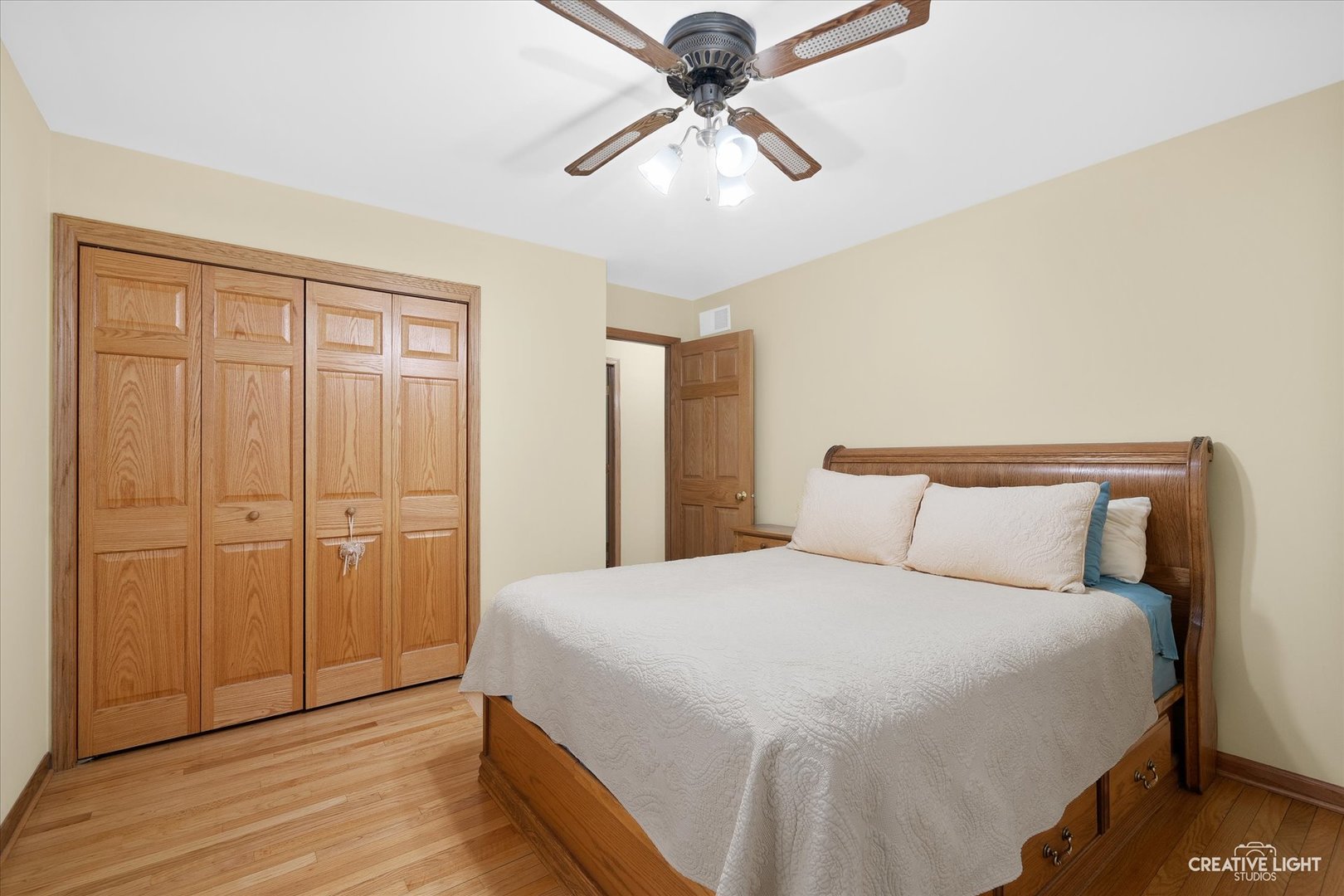 131 Terry Drive Sugar Grove, IL 60554 - Photo 10 of 27 a bedroom with a bed and a chandelier