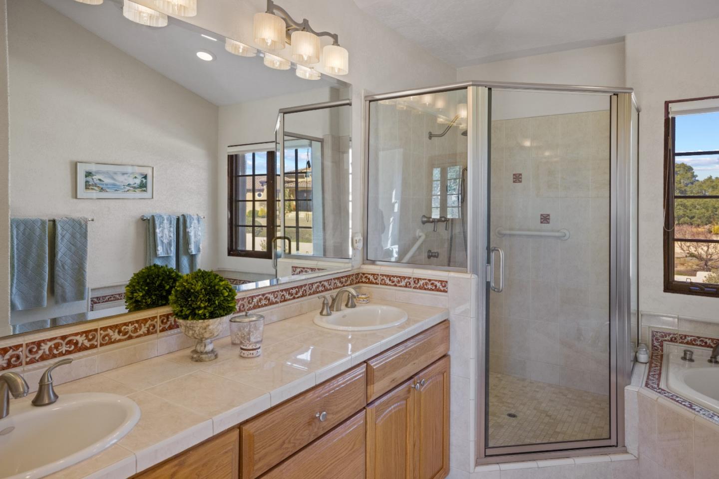12365 Saddle Road Carmel Valley, CA 93924 - Photo 25 of 65 a bathroom with a sink and a large mirror