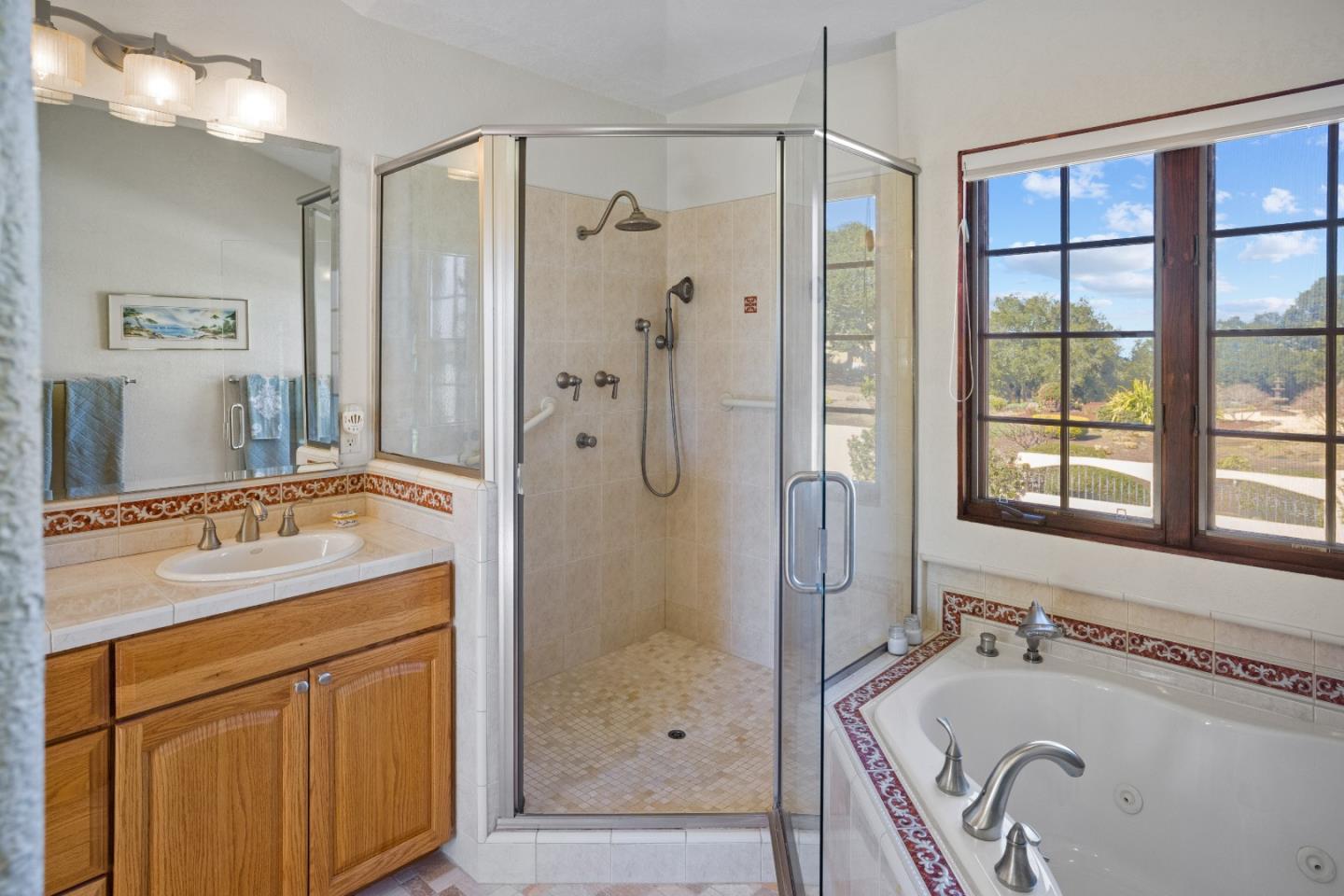 12365 Saddle Road Carmel Valley, CA 93924 - Photo 26 of 65 a bathroom with a granite countertop tub sink shower and mirror