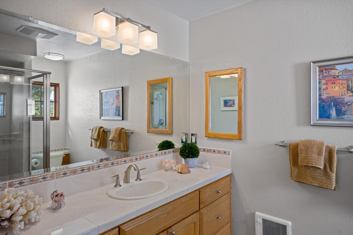 12365 Saddle Road Carmel Valley, CA 93924 - Photo 32 of 65 a bathroom with a granite countertop sink and a mirror