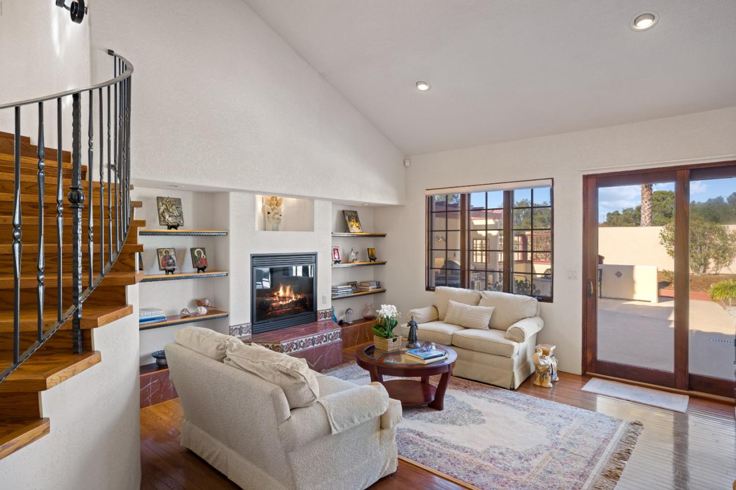12365 Saddle Road Carmel Valley, CA 93924 - Photo 33 of 65 a living room with furniture large window and a fireplace