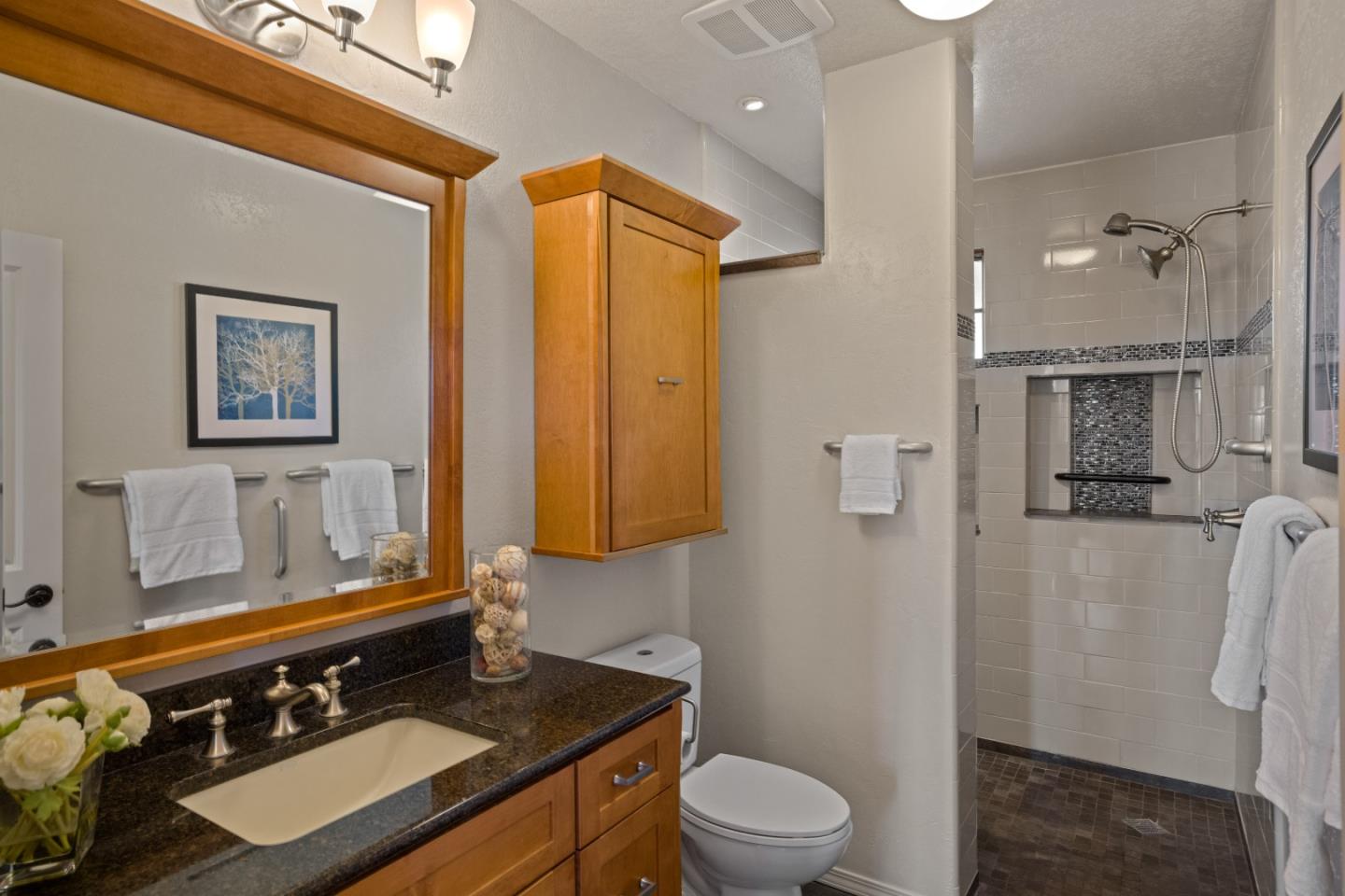 12365 Saddle Road Carmel Valley, CA 93924 - Photo 39 of 65 a bathroom with a granite countertop sink toilet and shower