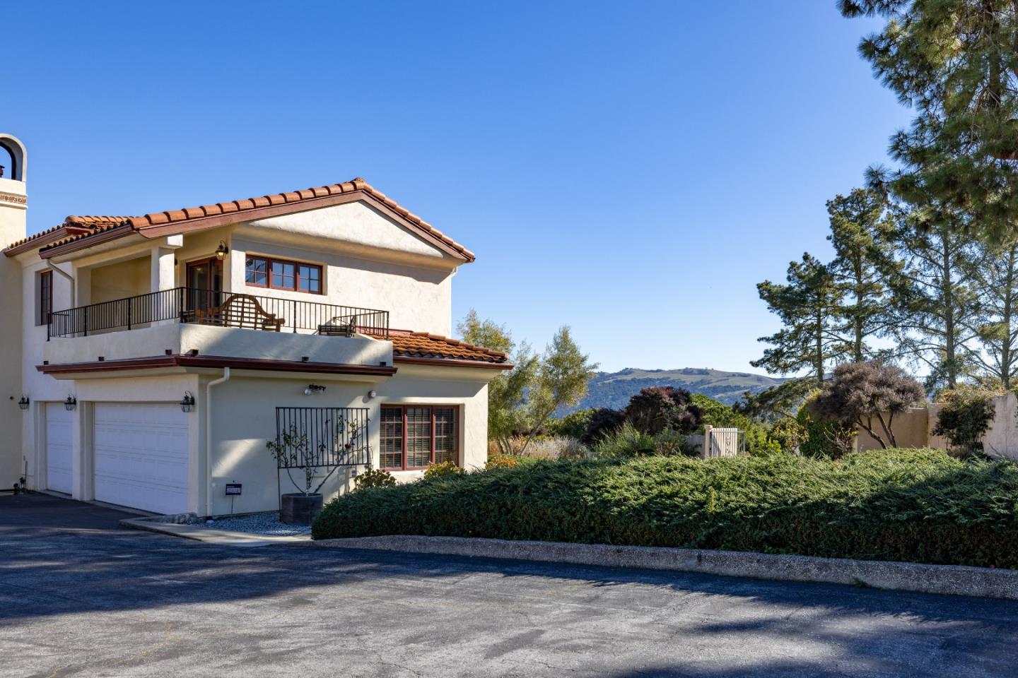 12365 Saddle Road Carmel Valley, CA 93924 - Photo 50 of 65 a front view of a house with a garden