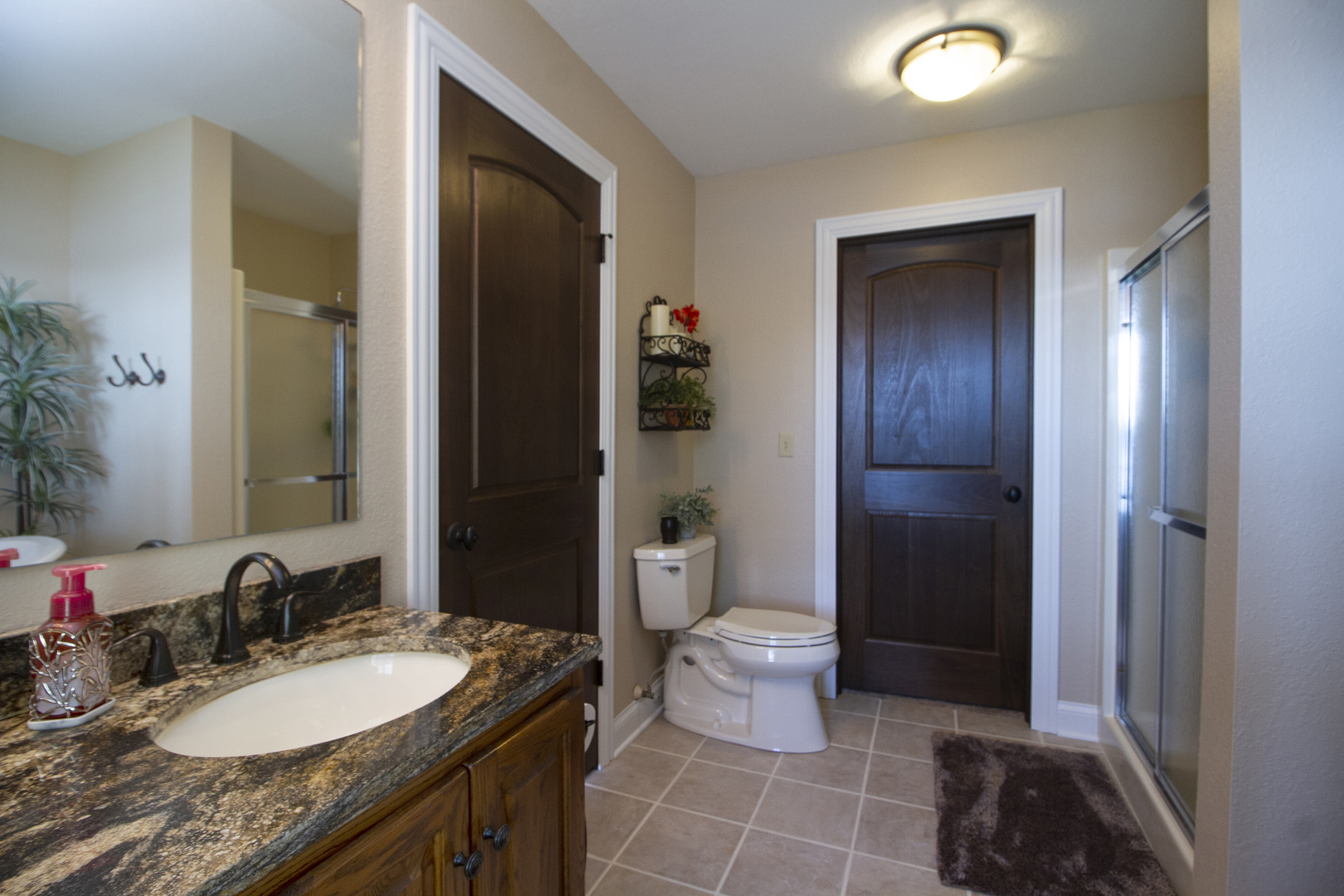 3157 River Road Kankakee, IL 60901 - Photo 19 of 50 a bathroom with a granite countertop sink a toilet and shower