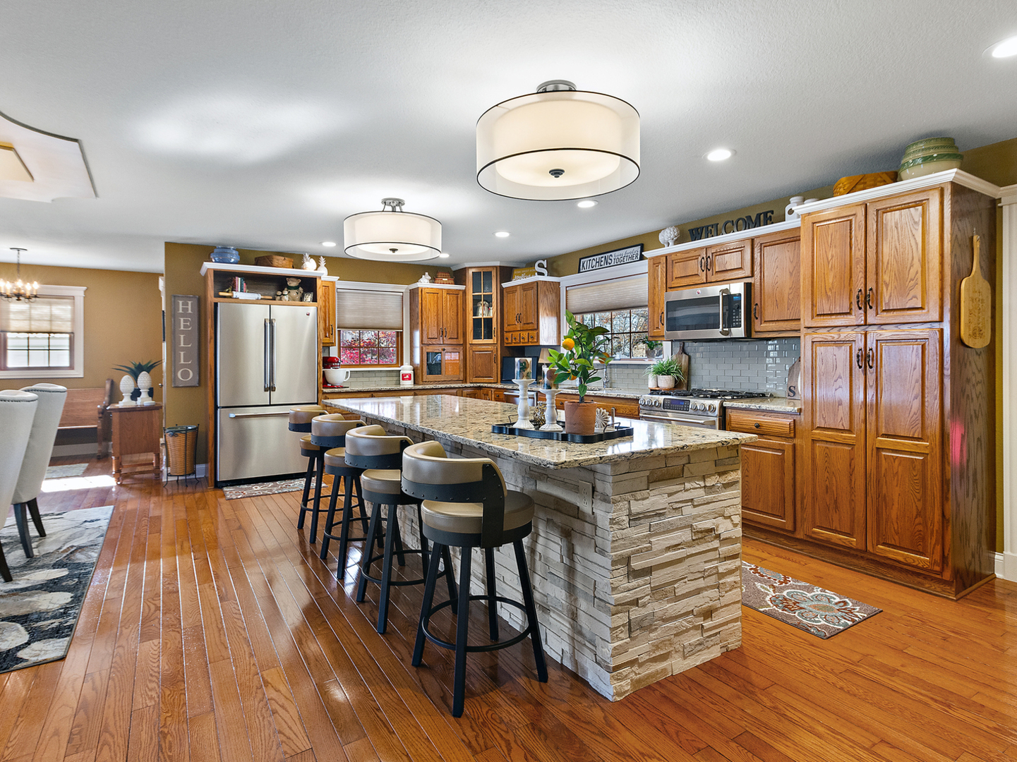 3157 River Road Kankakee, IL 60901 - Photo 8 of 50 an open kitchen with wooden floor and stainless steel appliances