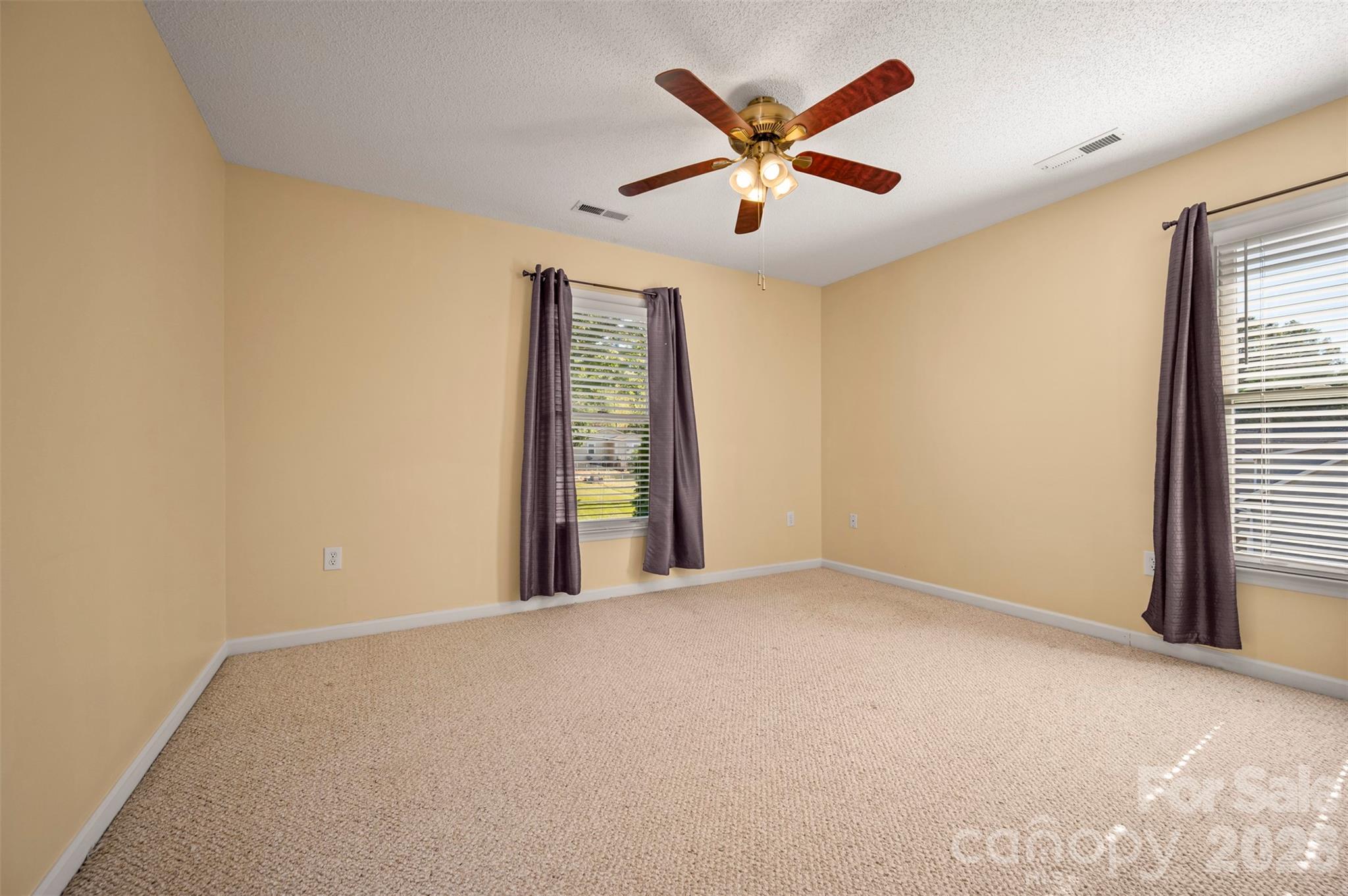 506 Pleasant Street Spindale, NC 28160 - Photo 22 of 42 an empty room with window and ceiling fan