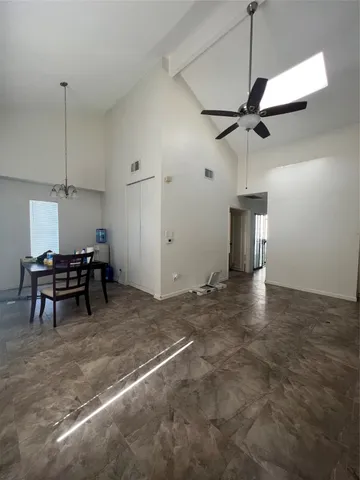 a view of a room with furniture and a ceiling fan