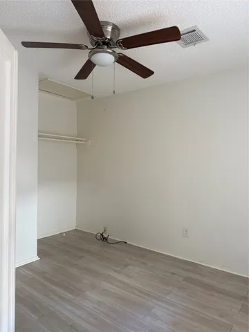 a view of a big room with a ceiling fan