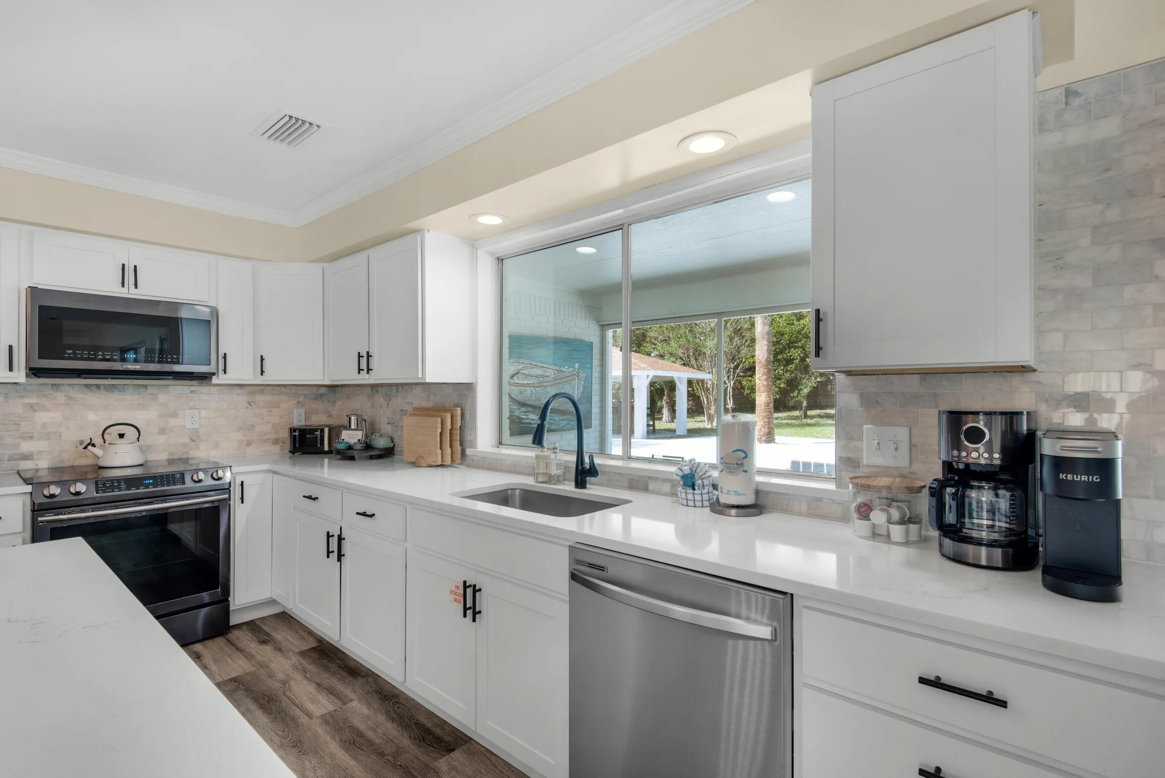 58 Overlook Drive Destin, FL 32550 - Photo 28 of 48 a kitchen with stainless steel appliances granite countertop a sink a stove and cabinets