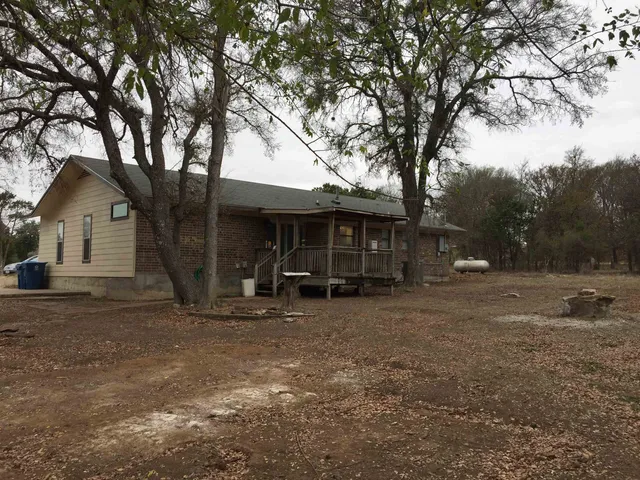 a view of a house with a yard covered in snow